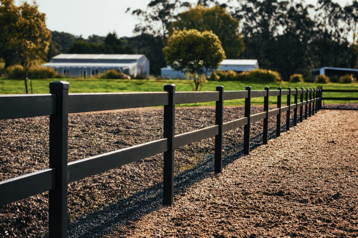 Kuptz 2-rail steel fence bordering a riding arena